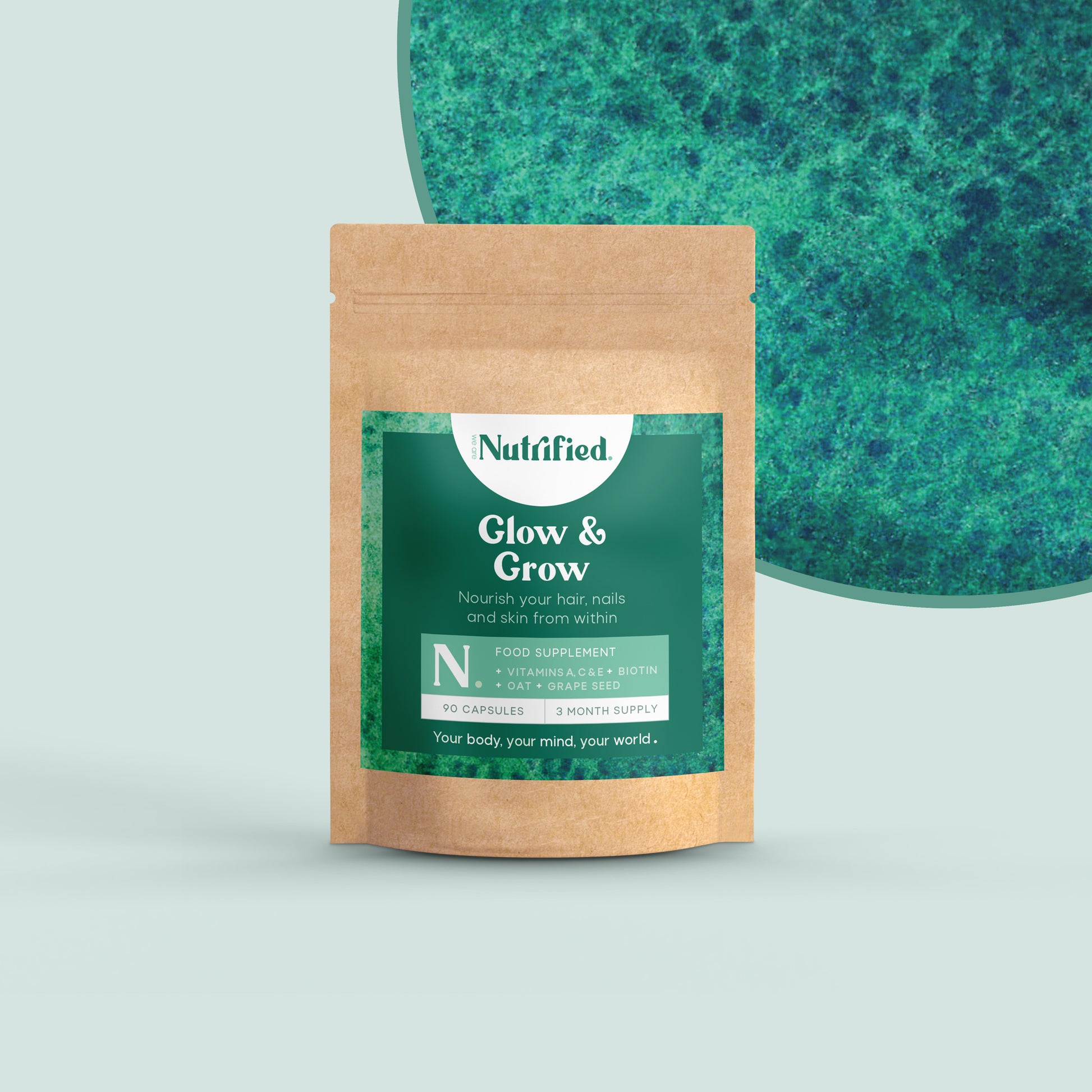A pouch of 60 Glow & Grow capsules with a background of a green textured surface.