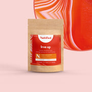 A pouch of Iron Up 90 capsules with a red label, placed against an abstract red background.